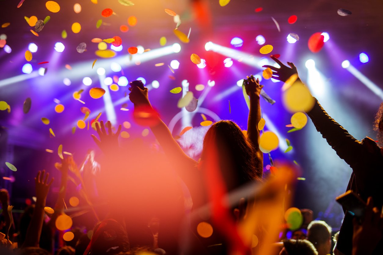 Confetti falling over the crowd on a music festival.