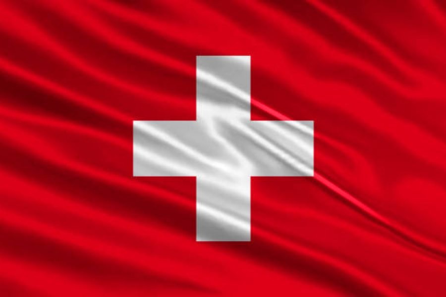 Switzerland flag design. Waving Swiss flag made of satin or silk fabric. Vector Illustration.