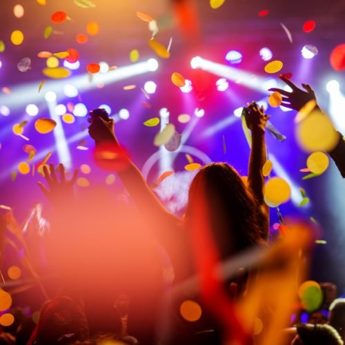 Confetti falling over the crowd on a music festival.
