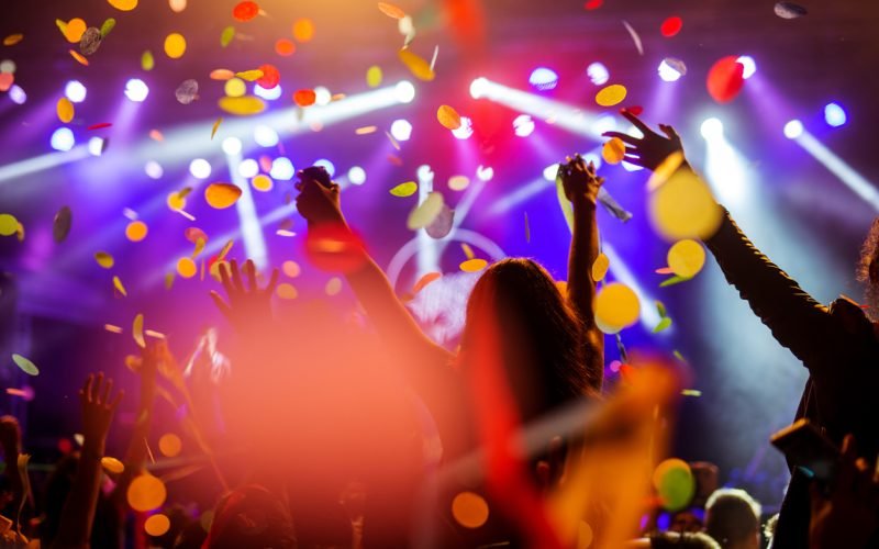 Confetti falling over the crowd on a music festival.
